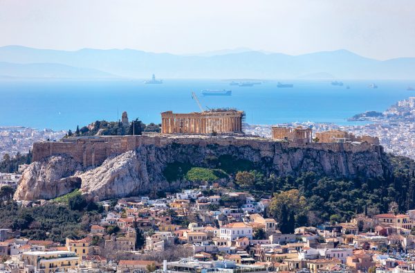 Athens, Greece. Acropolis and Parthenon temple, landmark. Ancient remains scenic view from Lycabettus Hill. Urban cityscape, blue sea and sky background